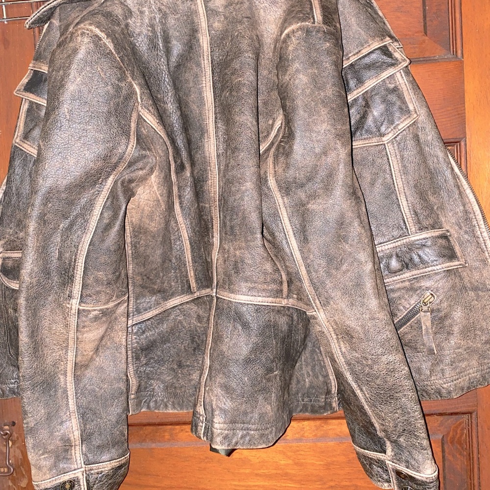 Brown distressed styled genuine leather jacket made by Route 66. Tight fitting.